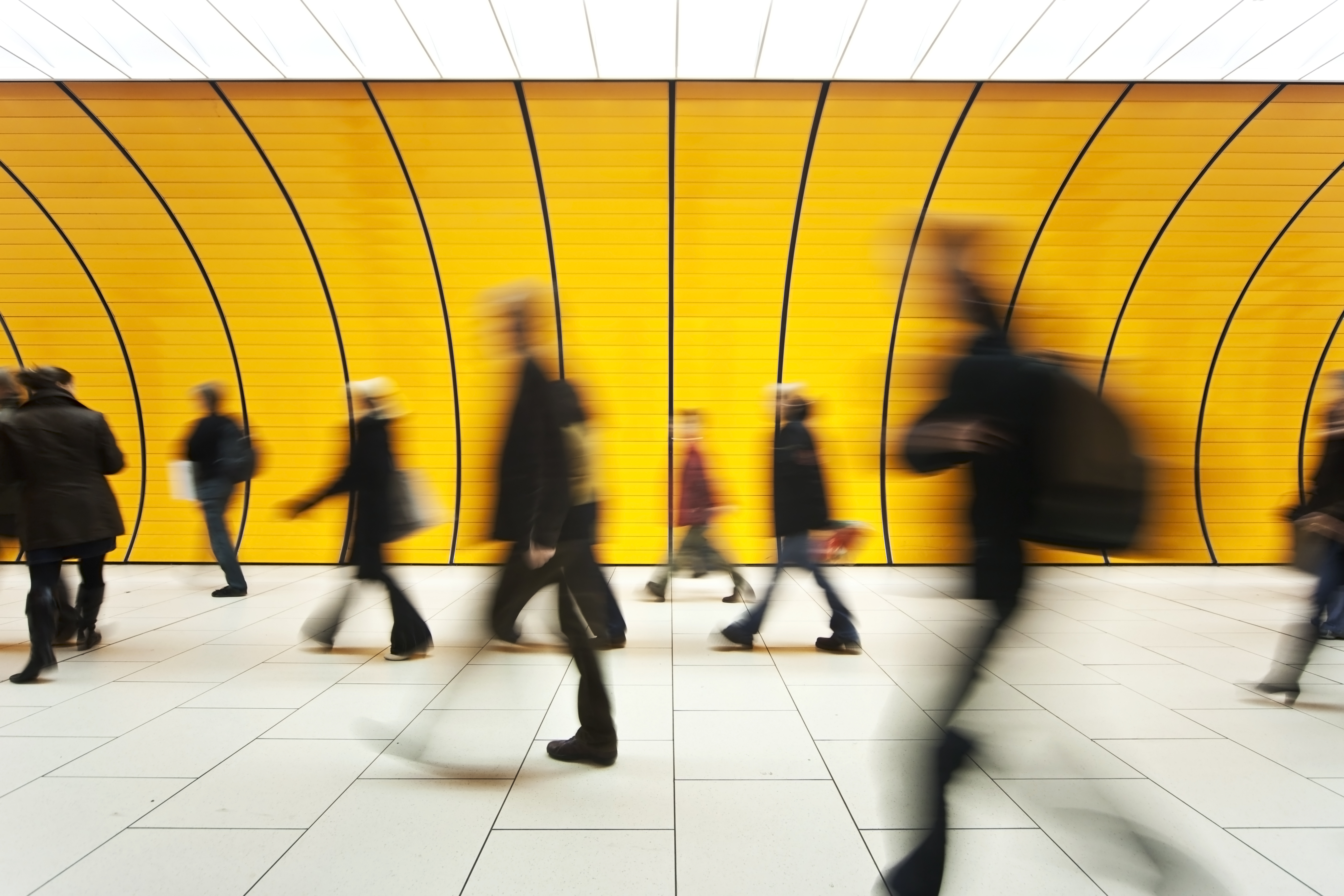 yellow tunnel, people walking, blur