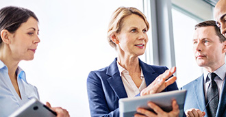 business woman delegating holding tablet