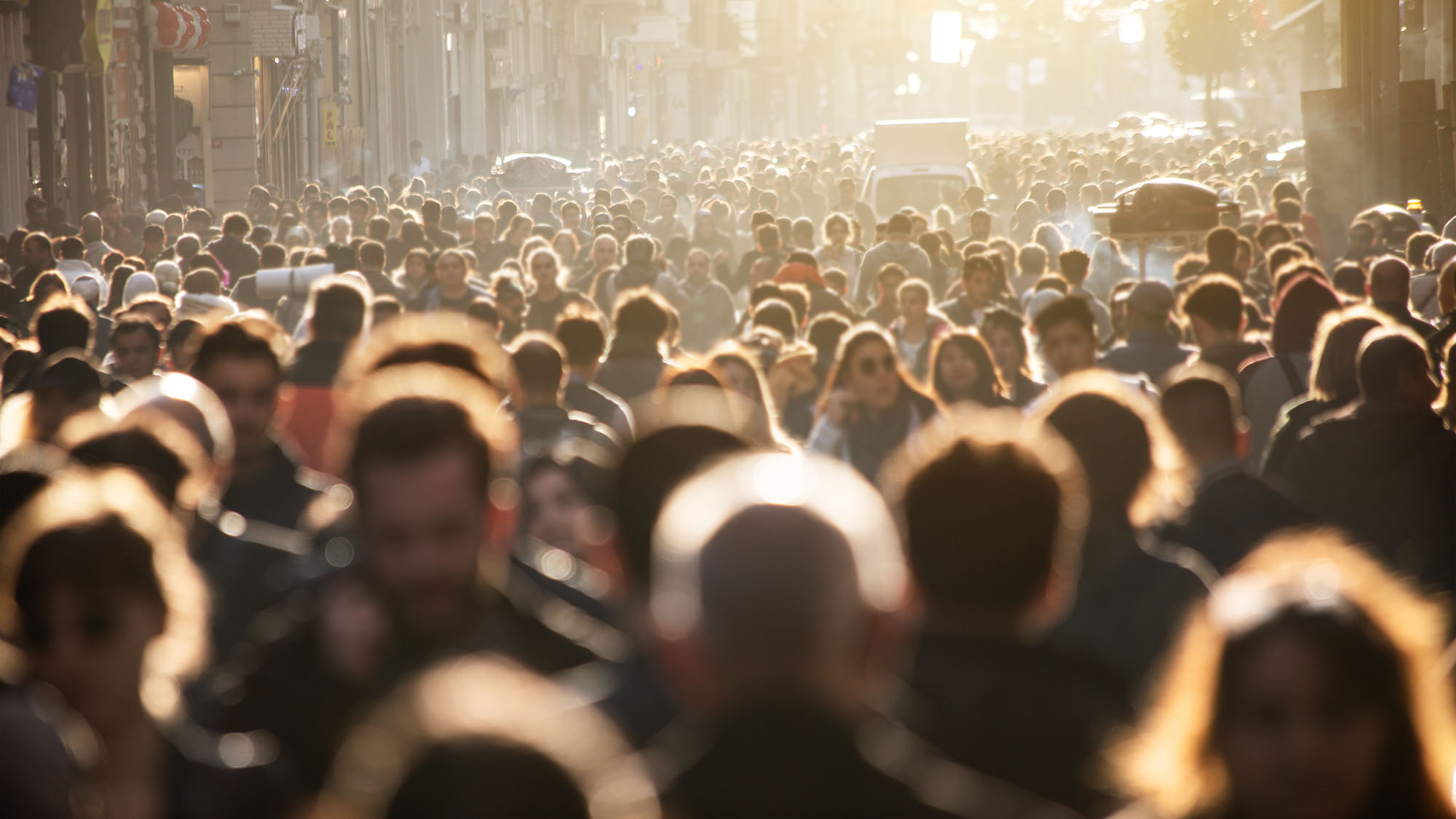 crowd of people walking on city street