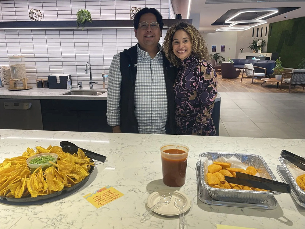 David Rojo Gonzalez and Glickman Colon of Adelante in New York office kitchen with snacks celebrating Hispanic Heritage Month