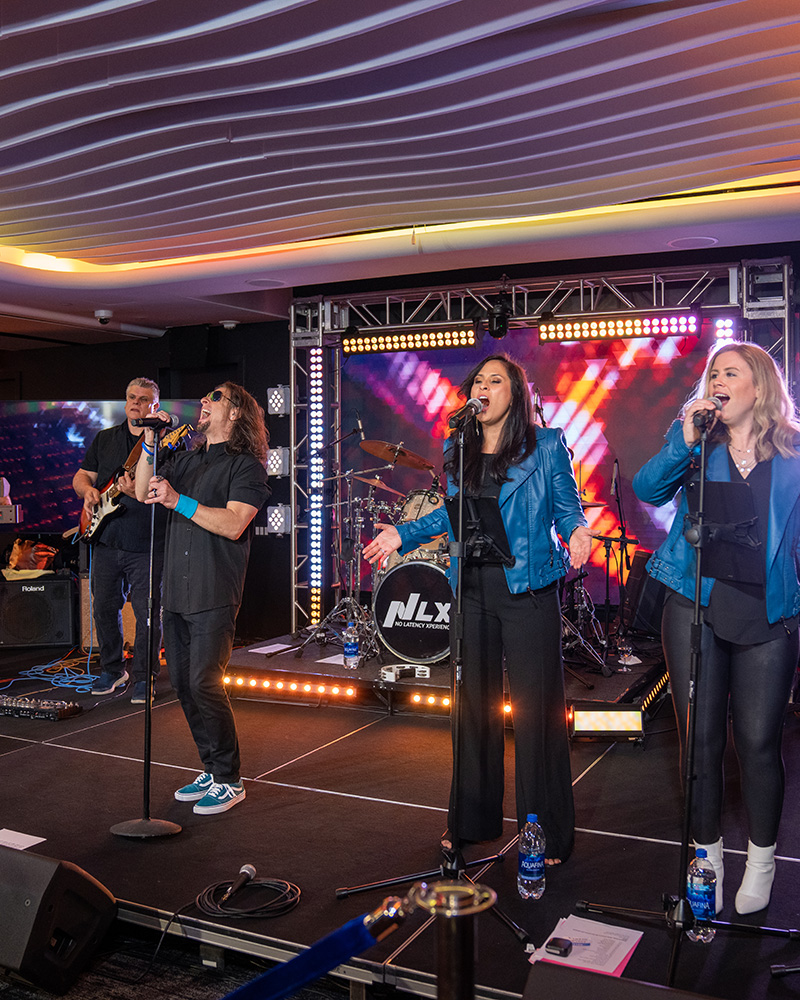 Concert stage setup with singers and band playing on stage at Nasdaq MarketSite