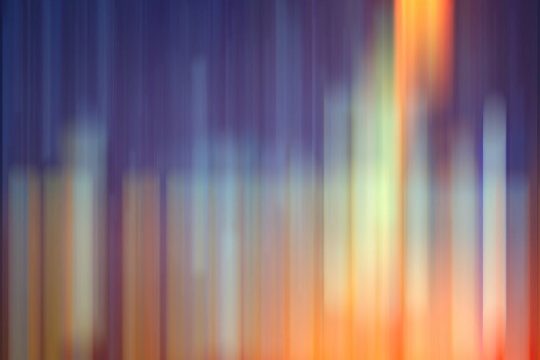 Placeholder for adobe stock photography of rainbow colored abstract stripes on a dark background.