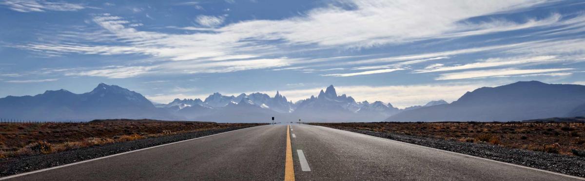 A road leading to mountains in the distance