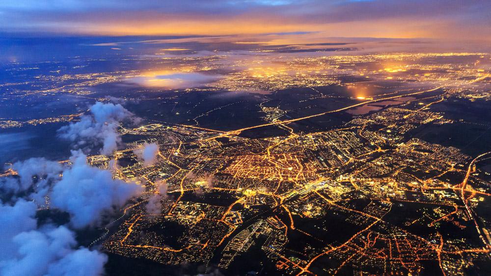 Adobe stock landscape photography of a cityscape at night in a dark blue and orange gradient.