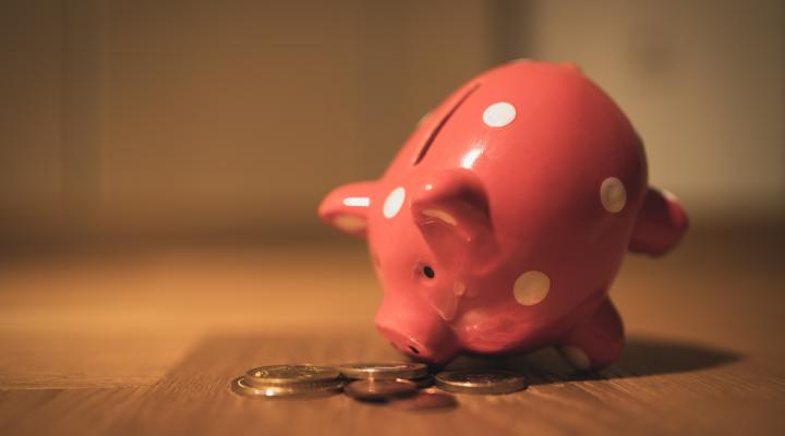 pink pig coin bank on brown wood table