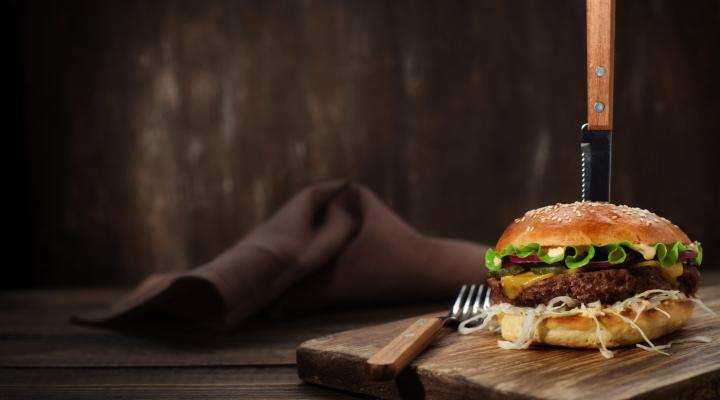 Hamburger with a knife pierced through it