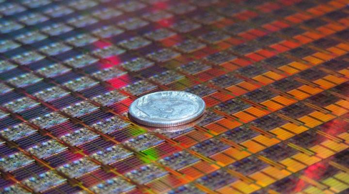 An Intel silicon wafer with a coin on top of it.