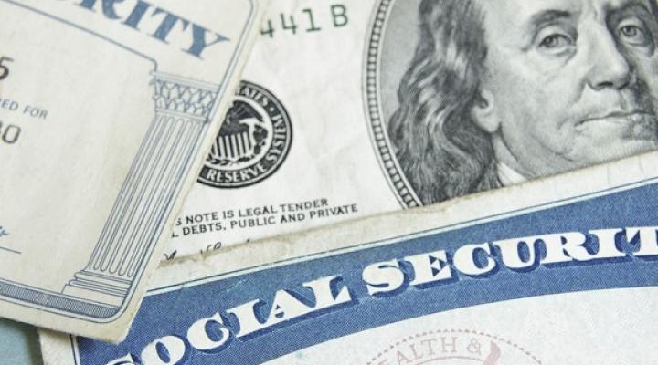 Social security card sitting on top of money