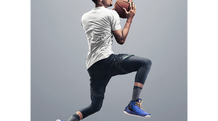 Steph Curry in casual-looking but athletic clothing jumping with a basketball.