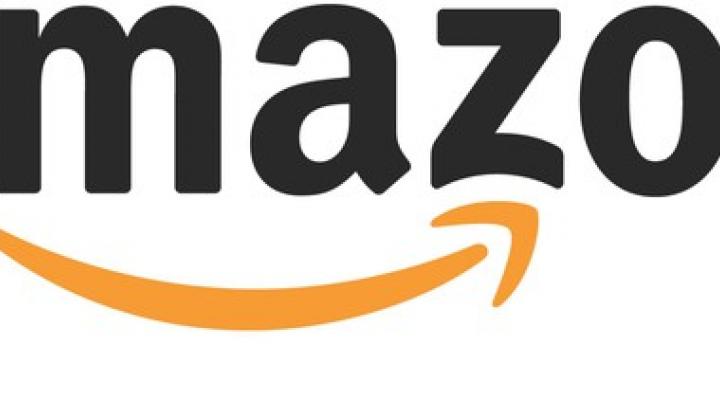 Amazon logo with black word Amazon and orange upward-pointing arrow.