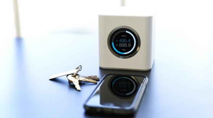 Ubiquiti Networks AmpliFy router on a table next to a smartphone and keys