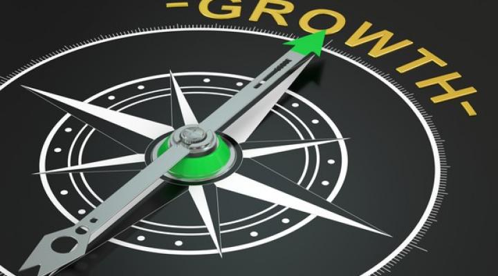 A compass pointing towards the word growth