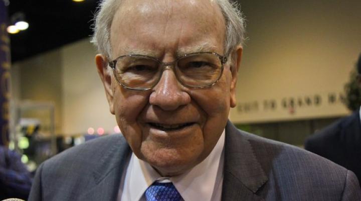 Warren Buffett smiles at the camera.