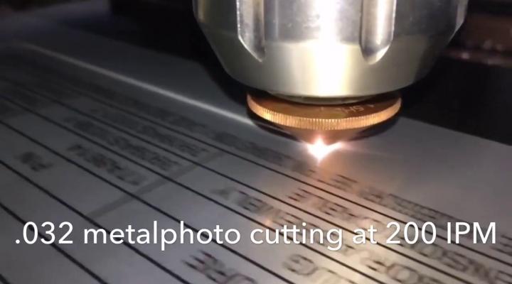 Laser cutting through a metal plate.