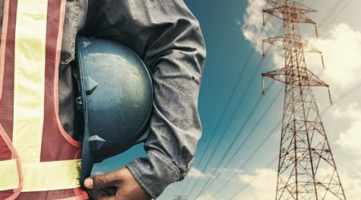 A man standing with power lines in the background