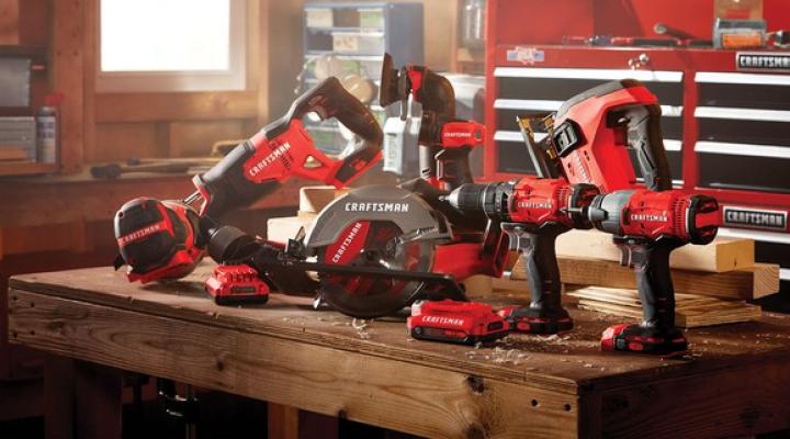 An assortment of Stanley Black & Decker's Craftsman-branded tools on a wood table in a workshop.