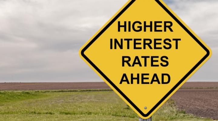 road sign that says higher interest rates ahead