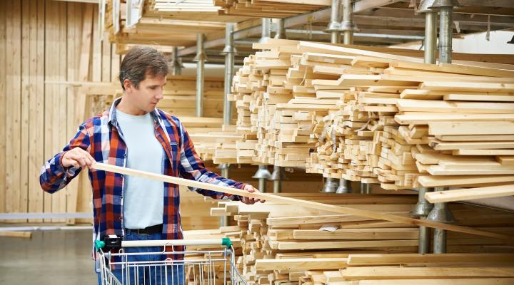 A shopper buys lumber.