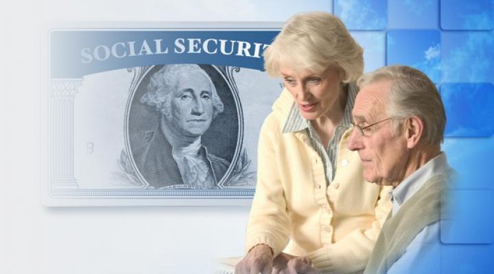 Older couple pictured next to a Social Security card frame with the $1 bill picture of George Washington in it.