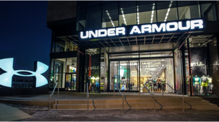 The entrance to an Under Armour store, with Under Armour on the marquee above the door and the company logo in the foreground.