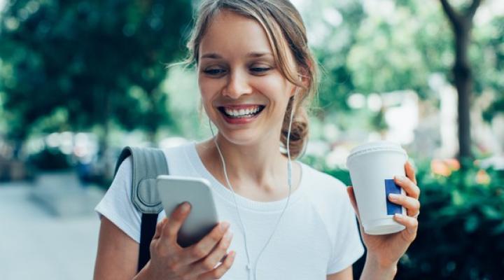 Smiling girl looking at smartphone