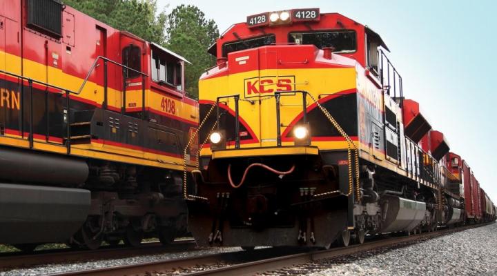 Two Kansas City Southern locomotives pass each other.