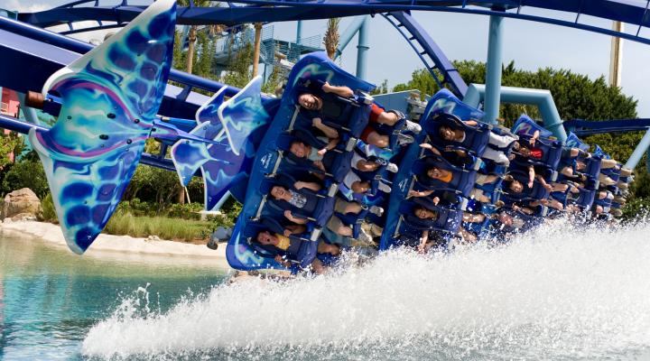 Manta roller coaster at SeaWorld Orlando splashing along the water.