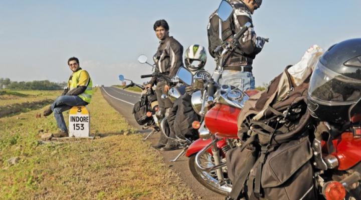 Indian motorcyclists stopped on side of road.