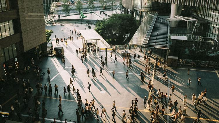 People walking across outdoor square